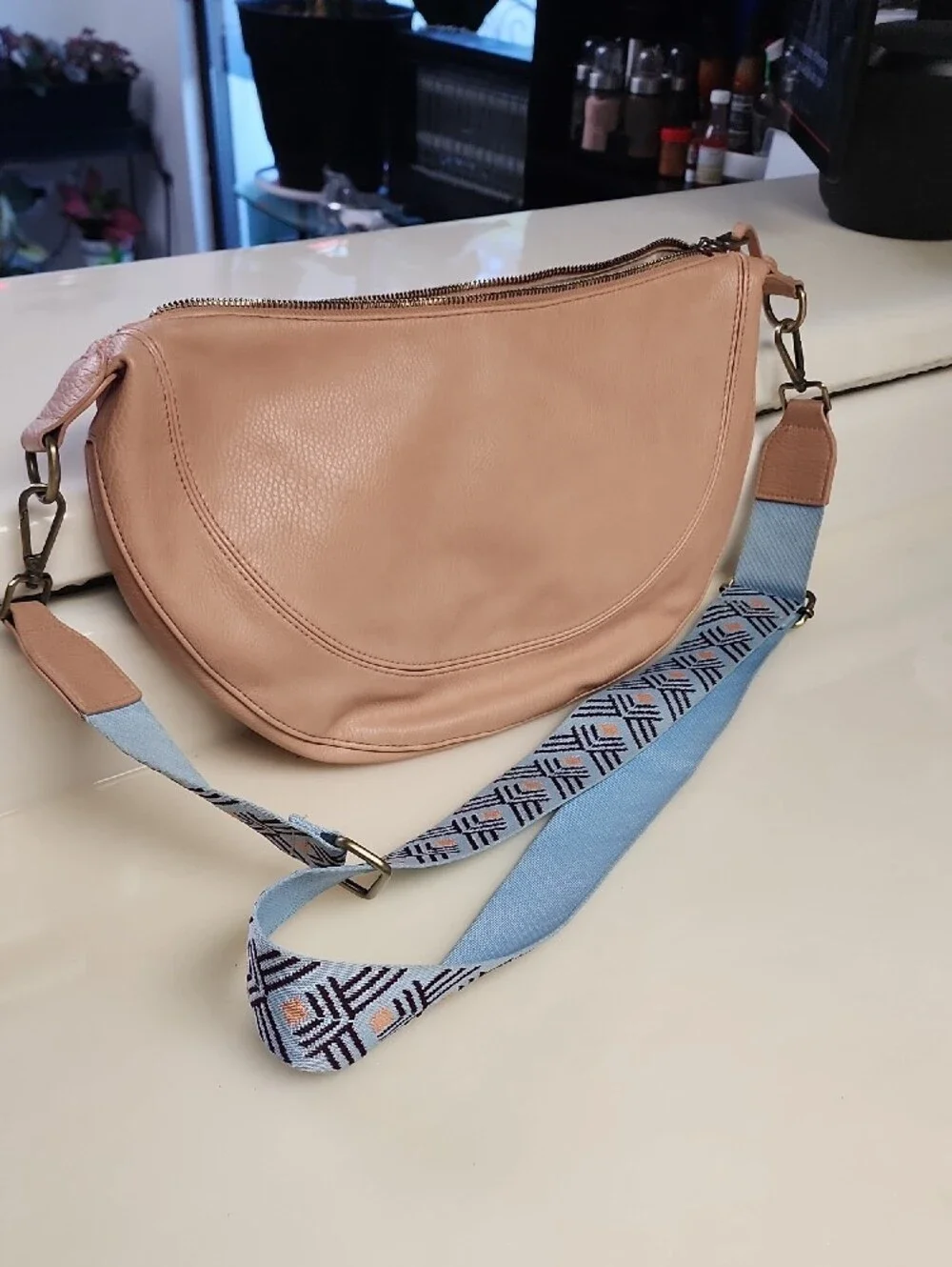 Urban Originals Peach Crescent Crossbody with Patterned Blue Strap